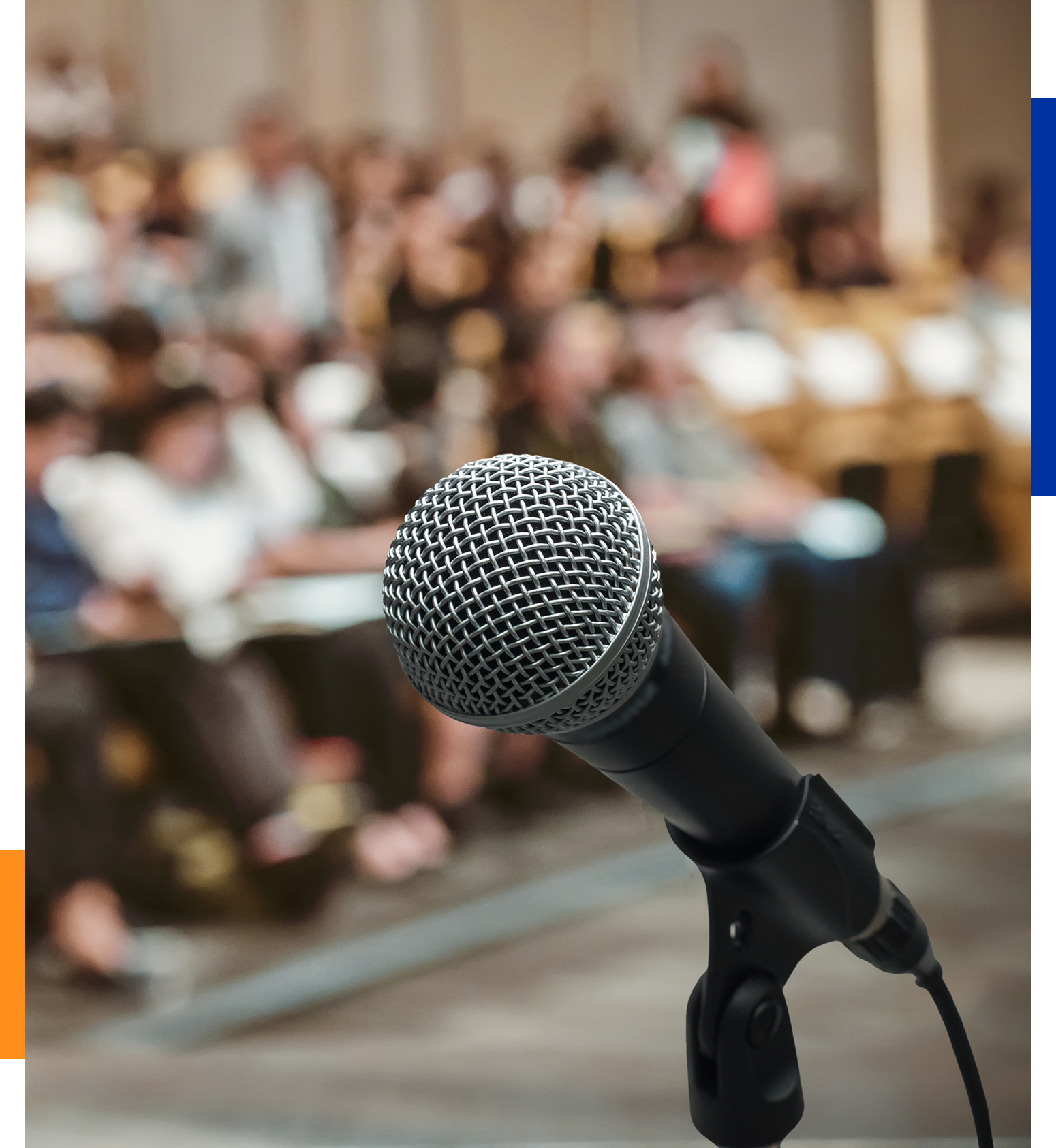 Microphone in front of a blurred audience.
